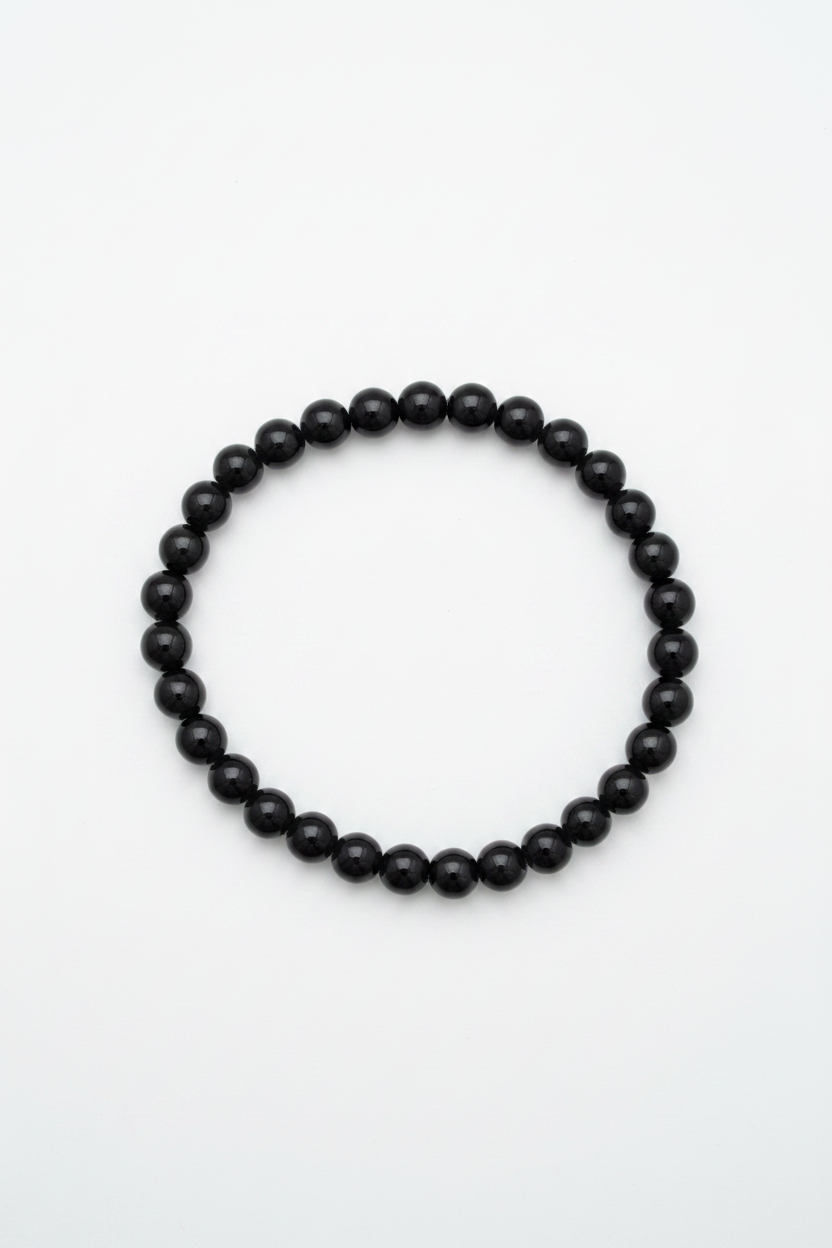 Pulsera de bolas de ónix negro natural sobre fondo blanco, joyería holística artesanal TheMagec