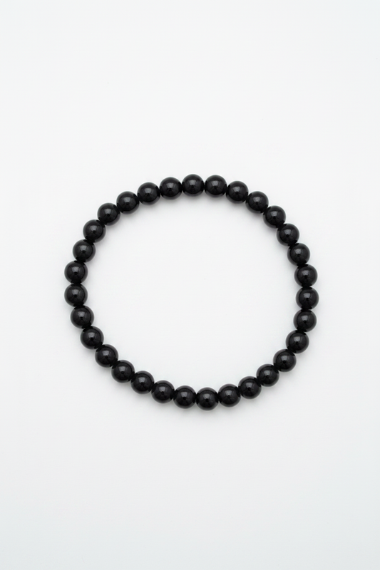 Pulsera de bolas de ónix negro natural sobre fondo blanco, joyería holística artesanal TheMagec